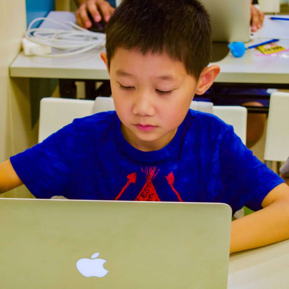 Student writing Python code in a small group online class with a Tiny Code teacher